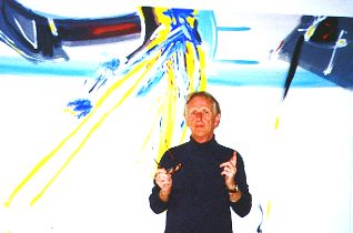 Ture Sjolander in front of a large painting on canvas, 2001.